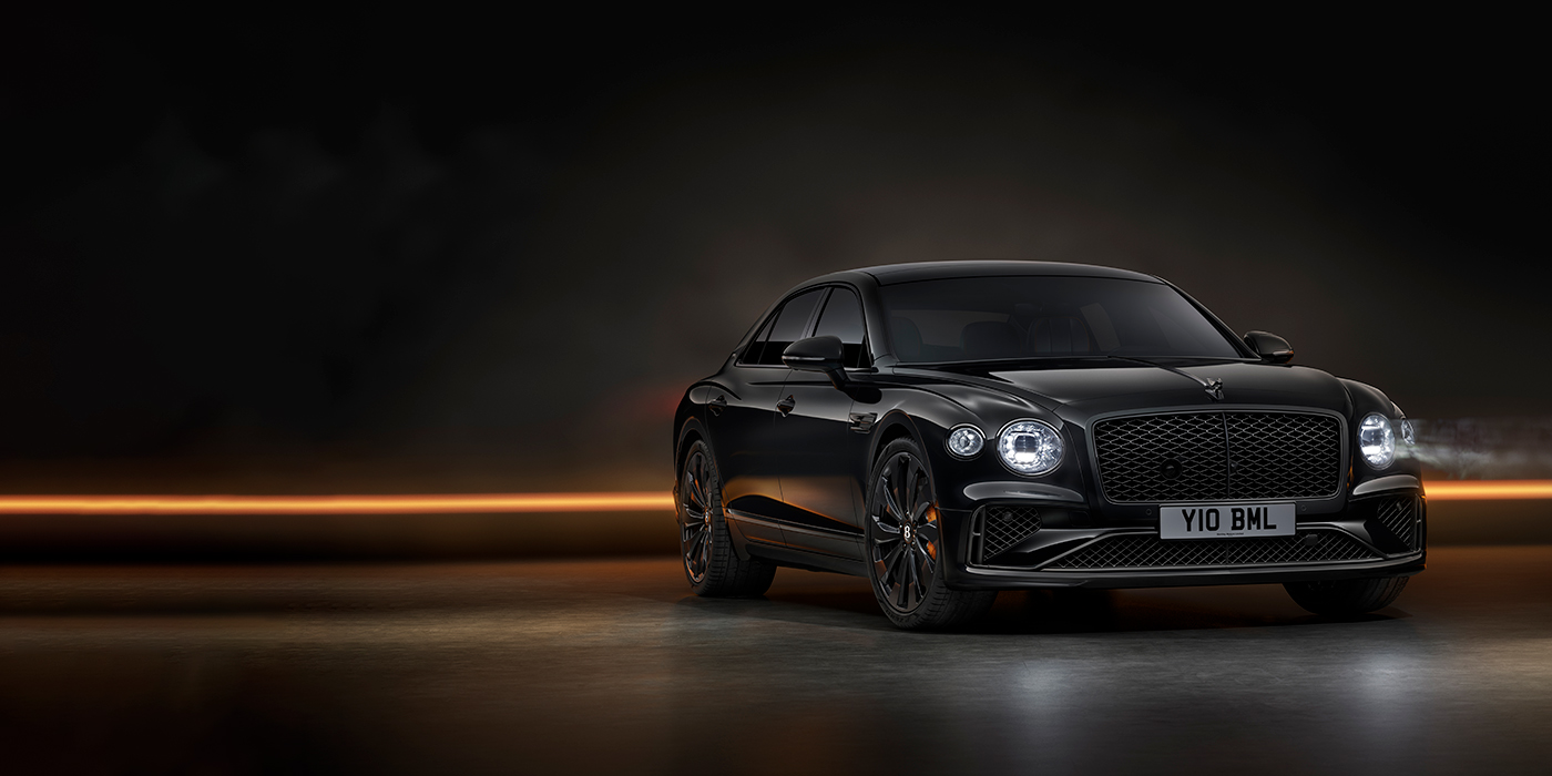 Bentley Bristol Bentley Flying Spur Black Edition sedan in Black Crystal paint against a dark grey and copper coloured background