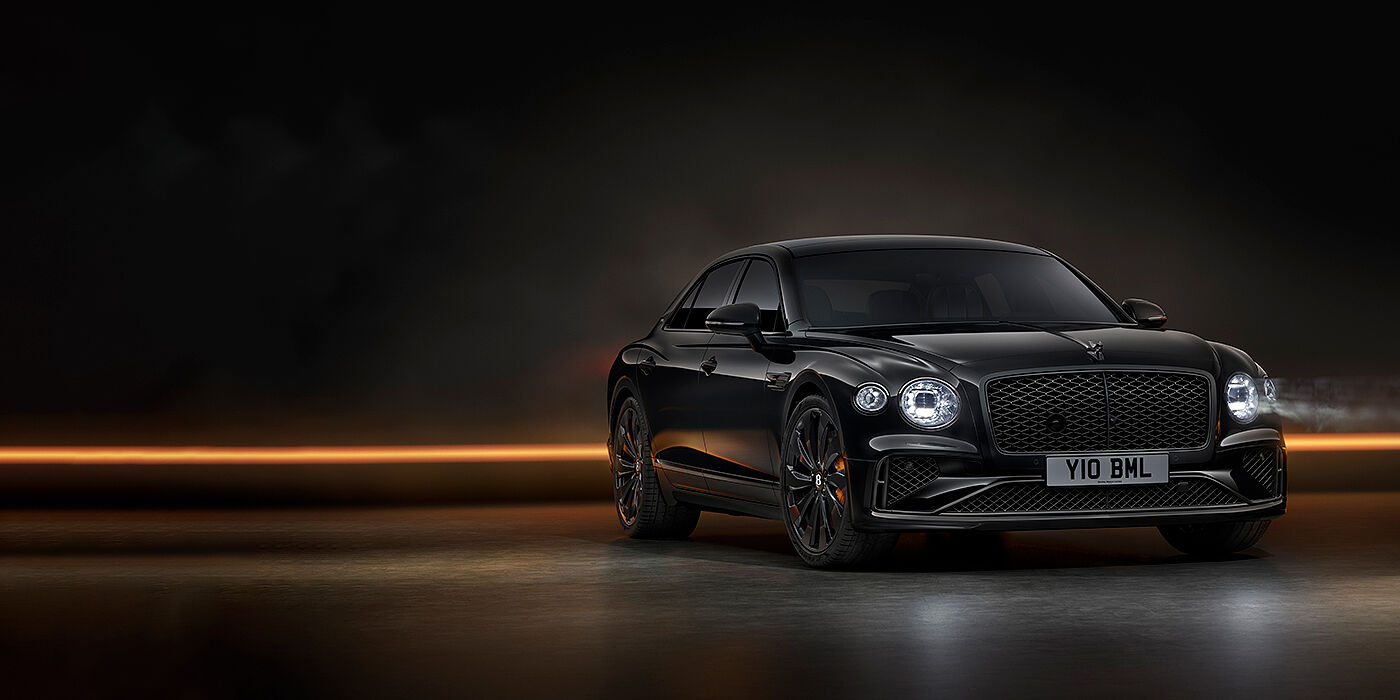 Bentley Bristol Bentley Flying Spur Black Edition sedan in Black Crystal paint against a dark grey and copper coloured background