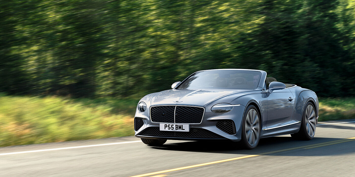 Bentley Bristol New Bentley Continental GTC convertible front view in Silverlake paint with 22 inch ten spoke wheels, driving dynamically on a country road