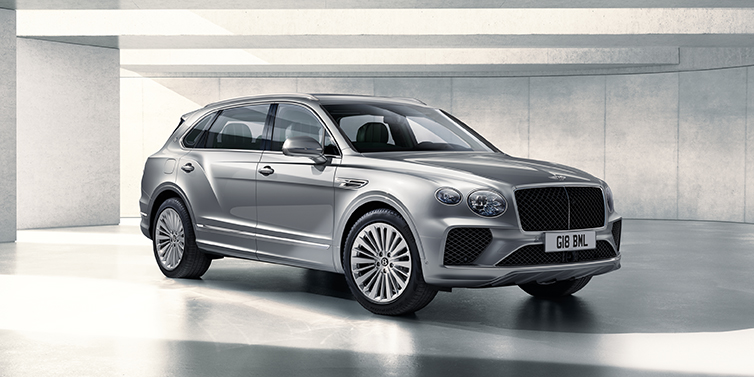 Bentley Bristol Bentley Bentayga Extended Wheelbase SUV front three quarter in Moonbeam paint with a grey background
